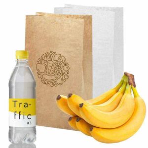 Bottiglia d'acqua in plastica accanto a sacchetti di carta e a un casco di banane